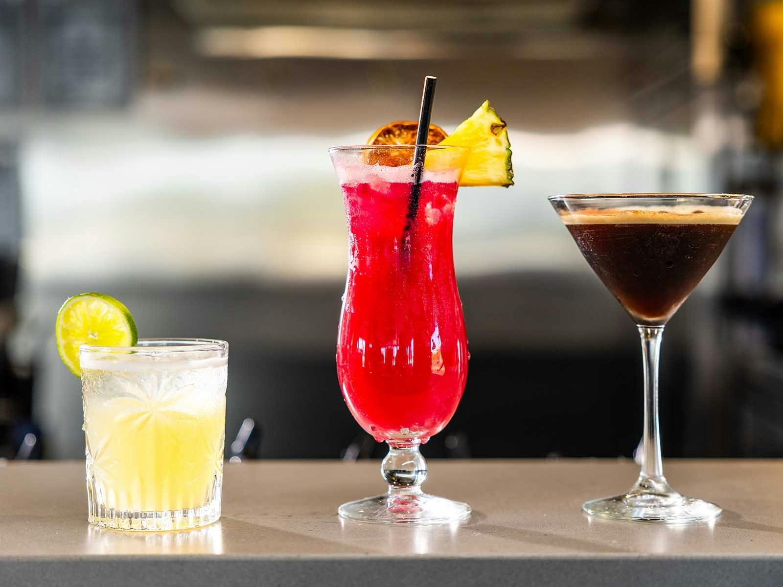 Three cocktails on a bar