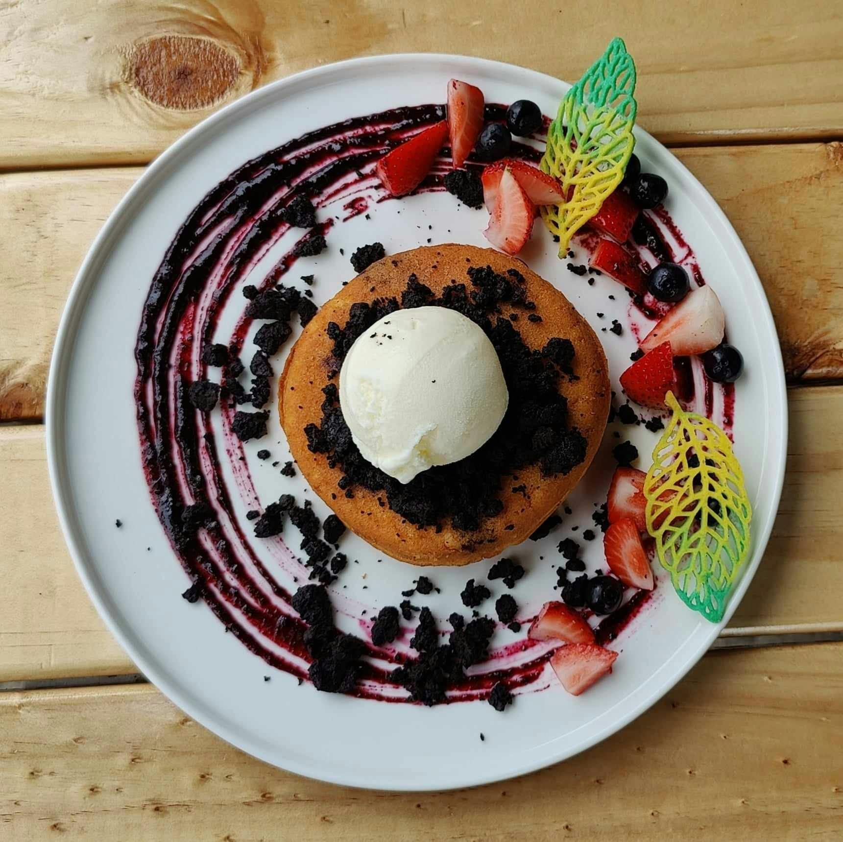 Thick fluffy buttermilk pancake, blueberry gel, blueberry, strawberry, cookie crumbs, ice cream