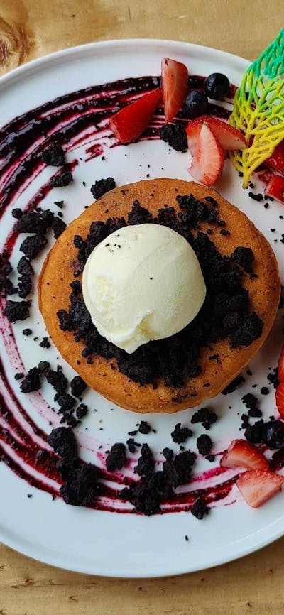 Thick fluffy buttermilk pancake, blueberry gel, blueberry, strawberry, cookie crumbs, ice cream