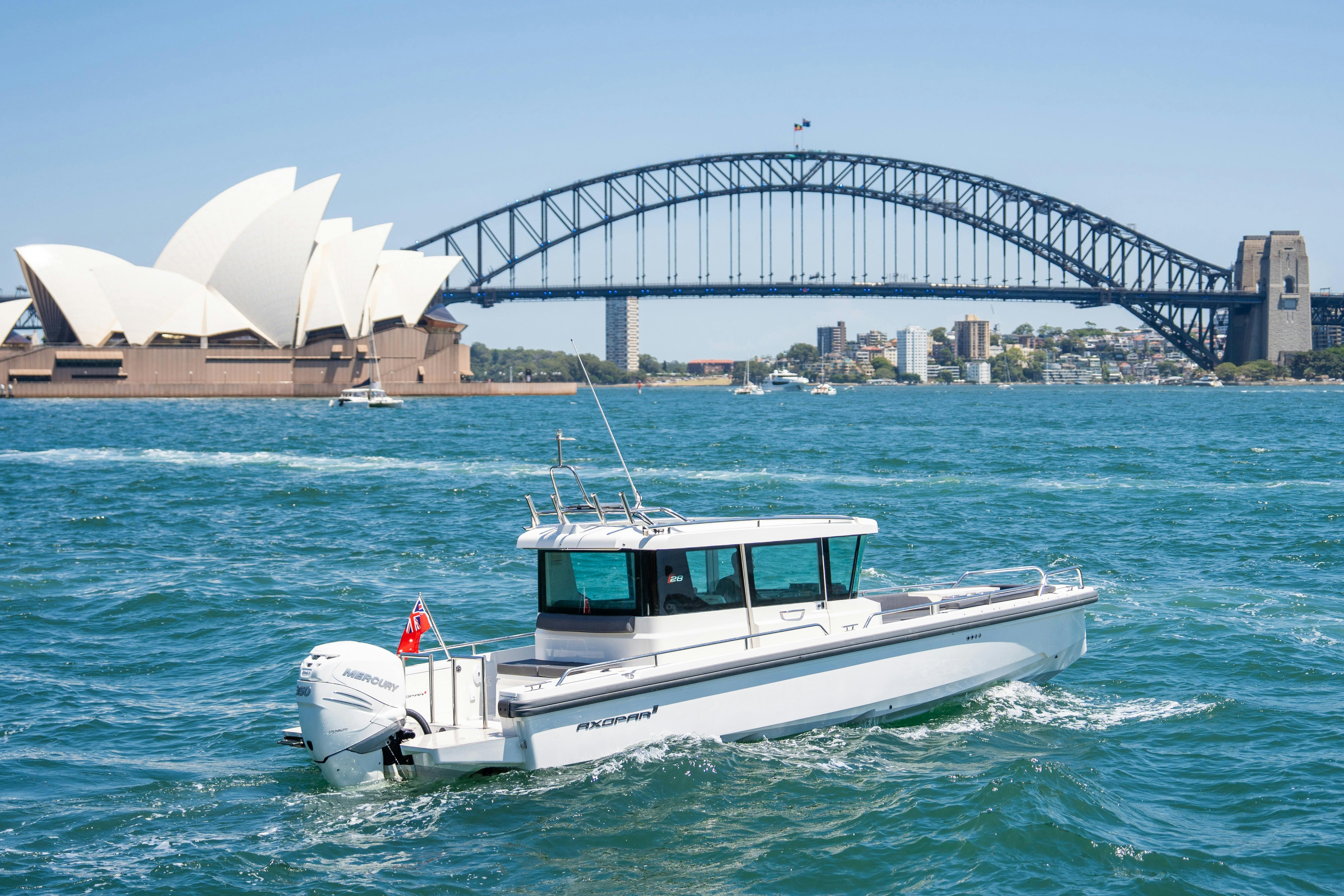 Luxury motor yacht cruising on Sydney Harbour with city skyline in the background