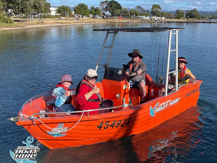 Family on orange polycraft boat.