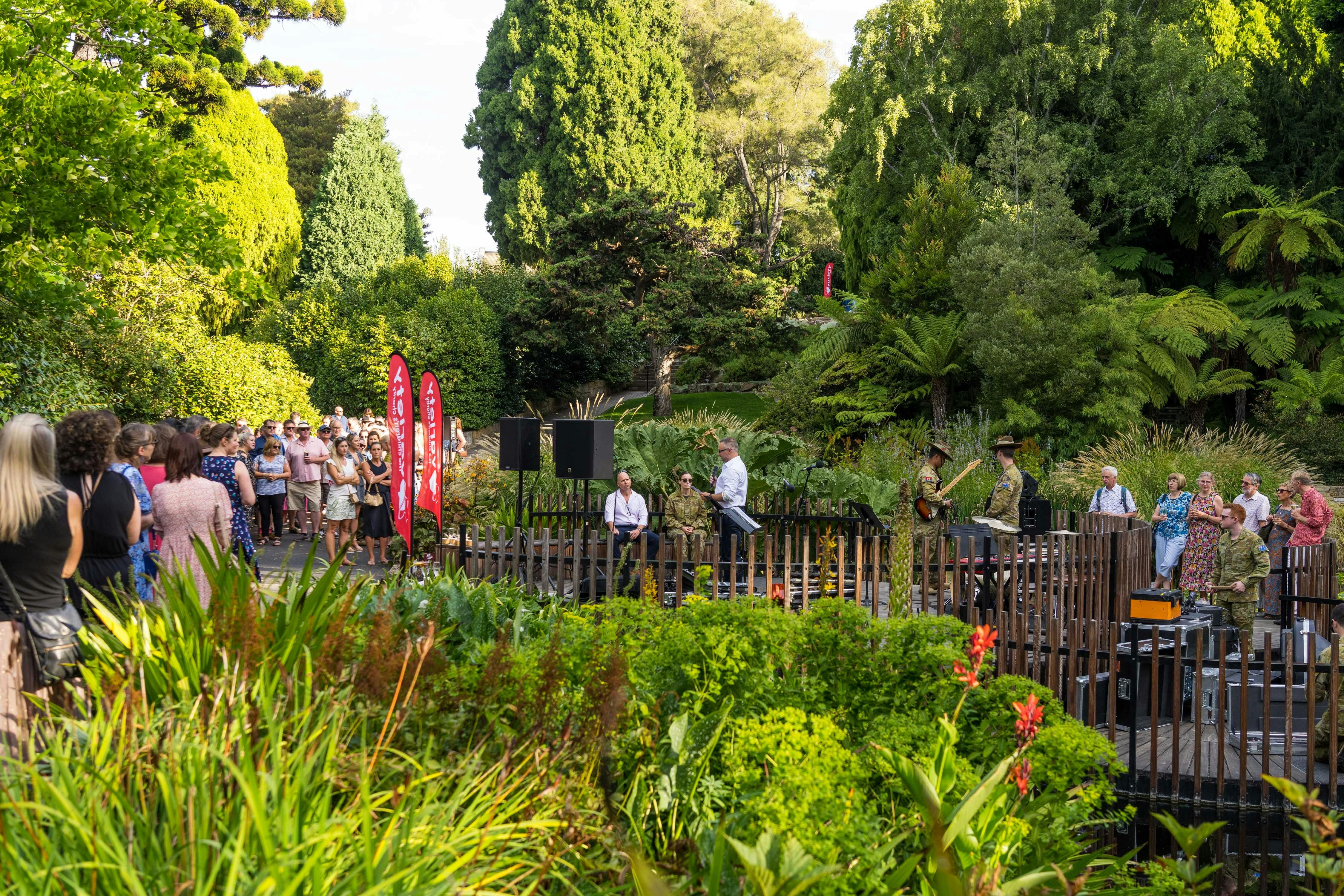 gathering of people in the garden as the sun sets
