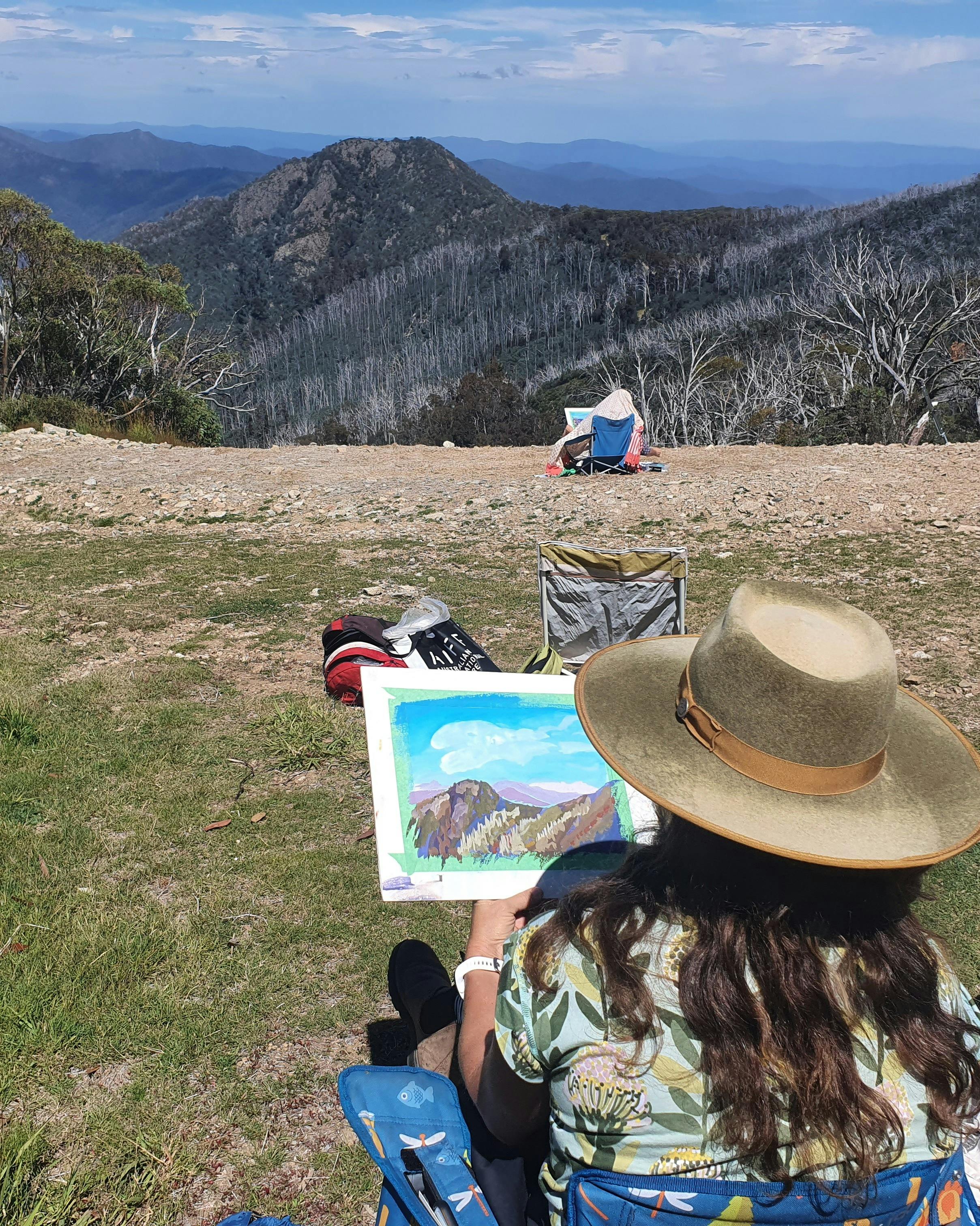 artist paints the view of mountains