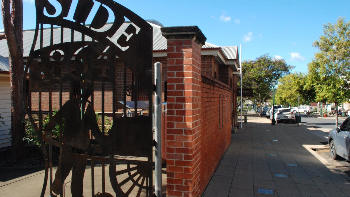 photo of the footpath running past The Bond Store with achievers walk plaques inthe footpath