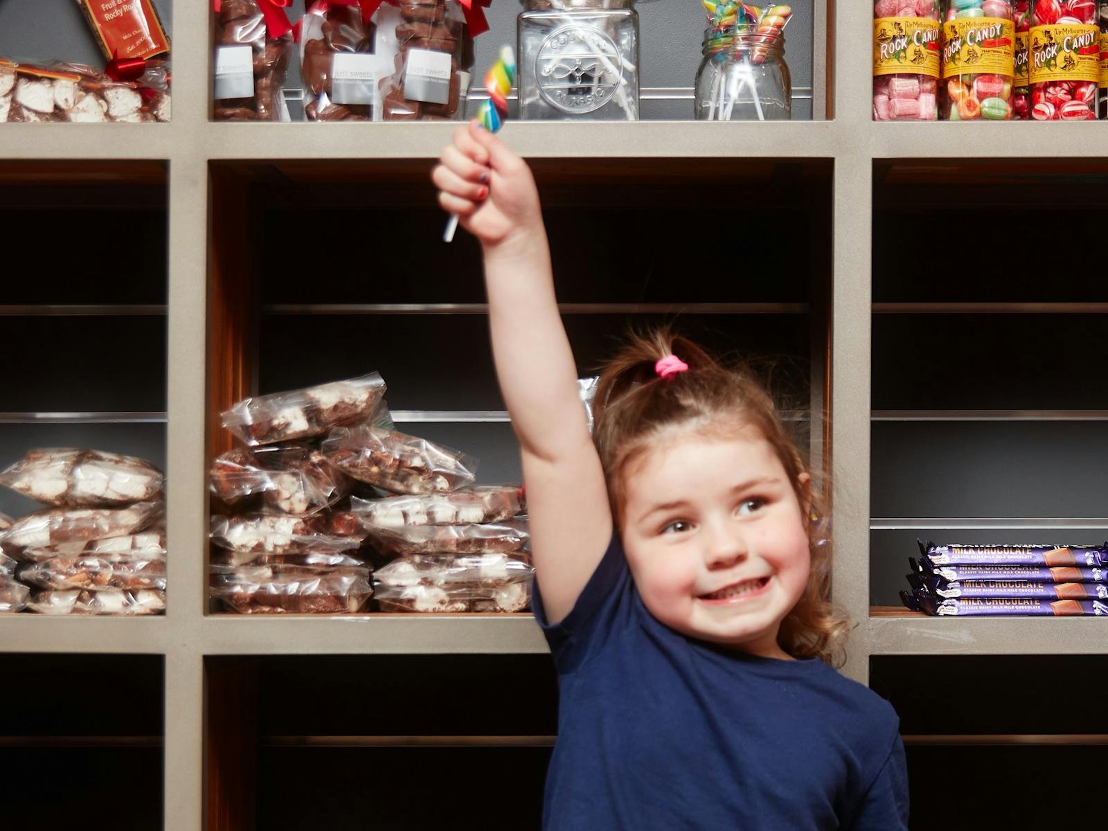 Young child holding a candy