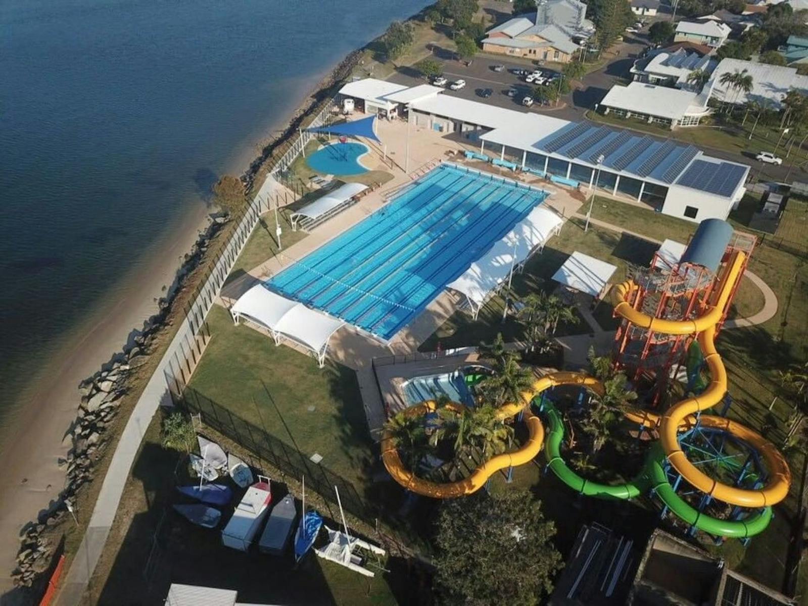 Aerial shot of the pool and waterslides next to the river