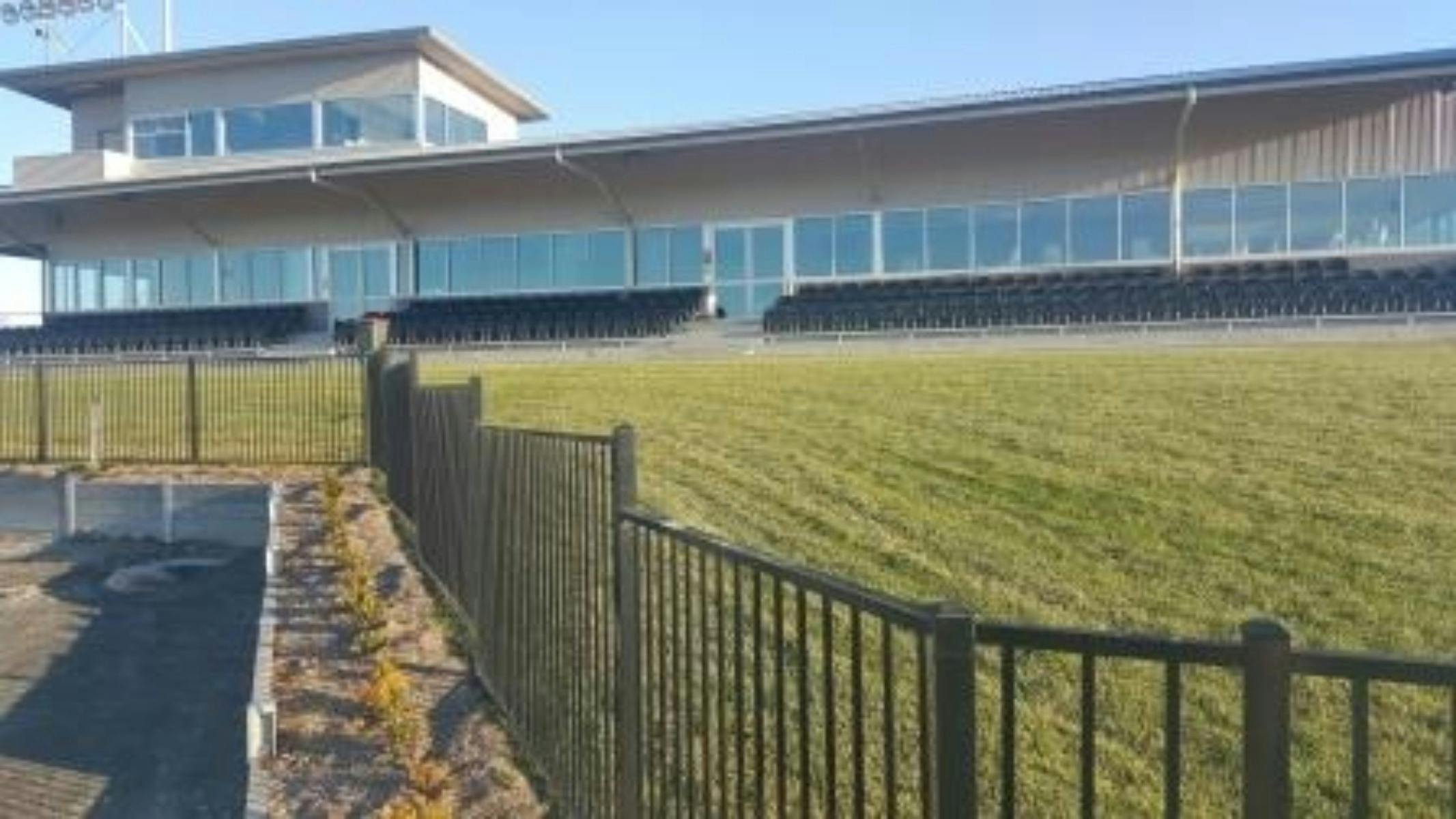 club house, grass, black fencing