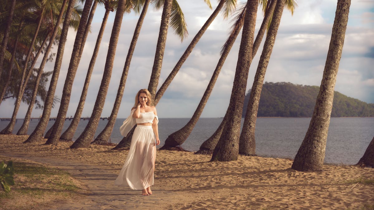 Professional holiday photography session at Palm Cove Beach QLD with tropical palm trees, sandy shor