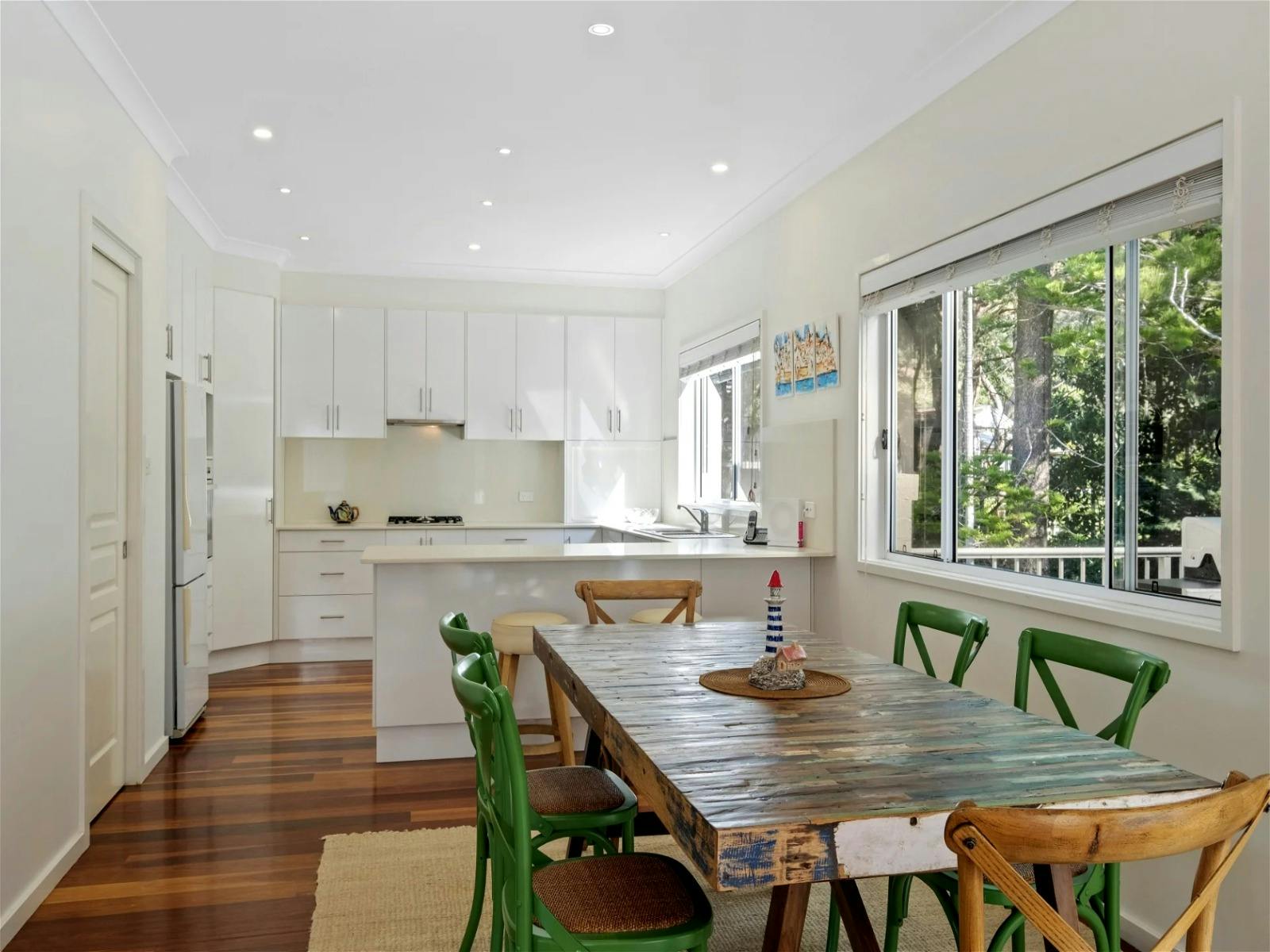 Dining area with a table comfortably seating six guests, perfect for gatherings and meals together