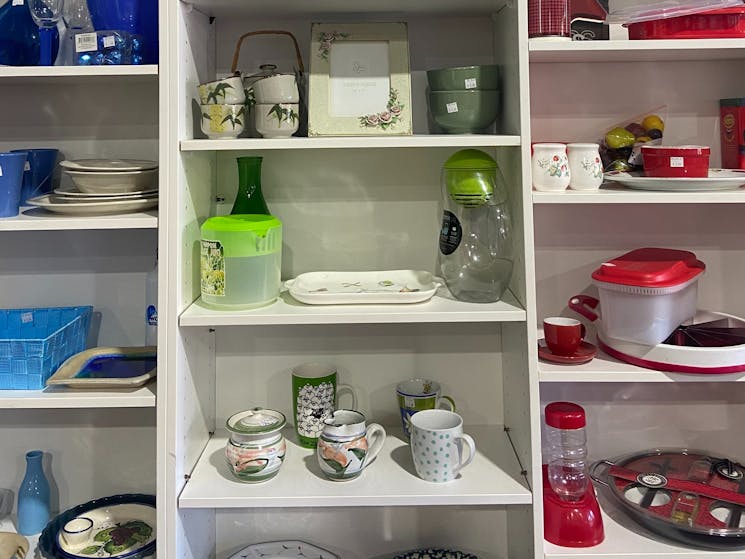 Display shelf showing homeware by colour.
