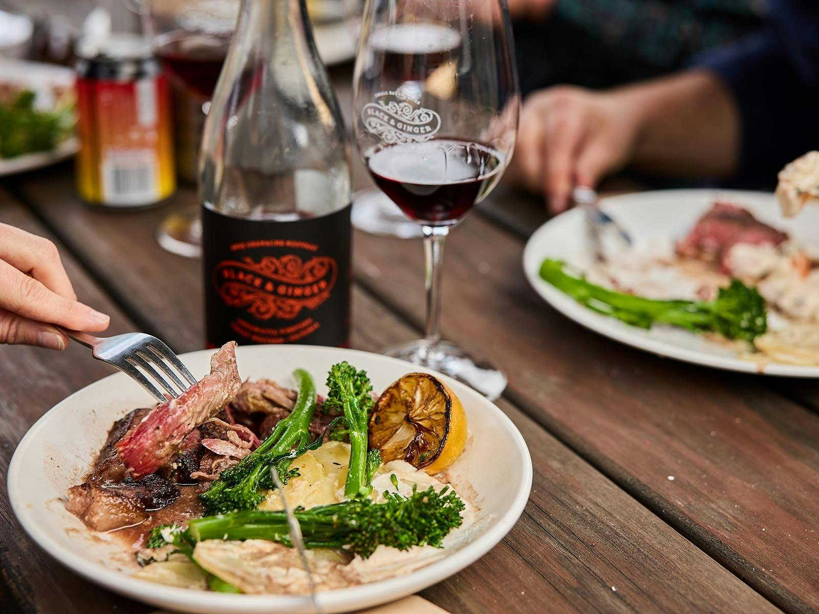 Long Lunch food with a glass and bottle of Grenache Nouveau