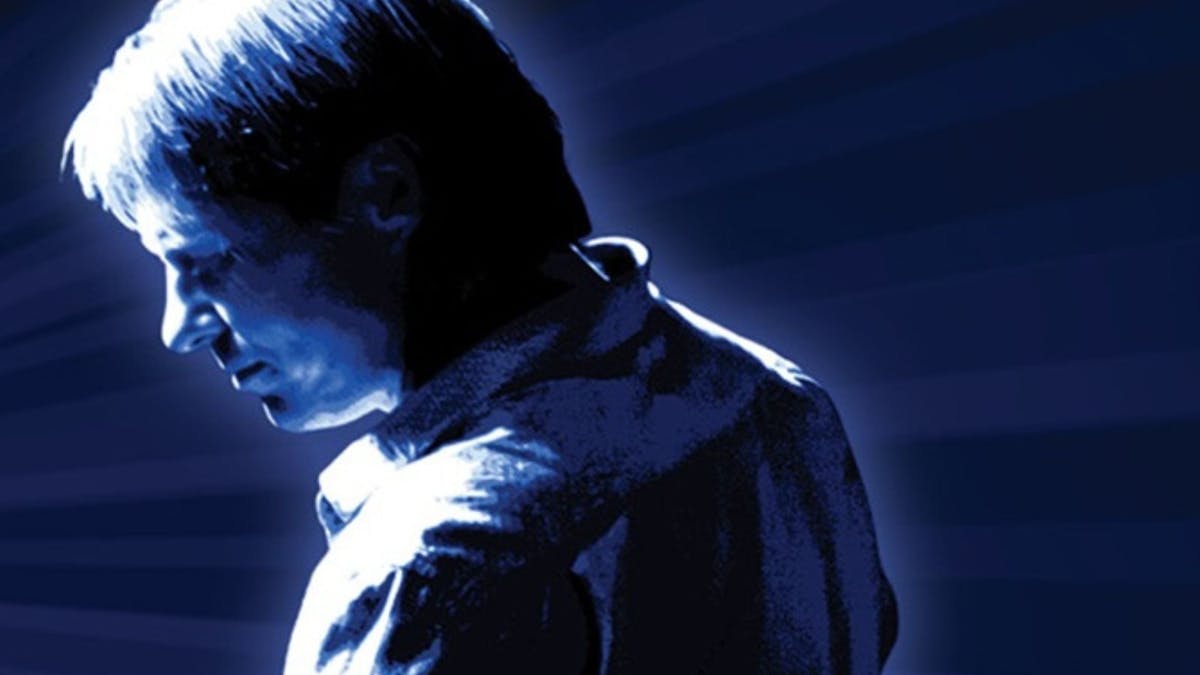Silhoutte of Darren in dark blue background