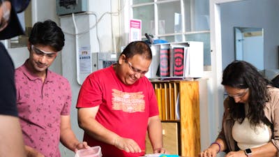 Visitors making glass tiles