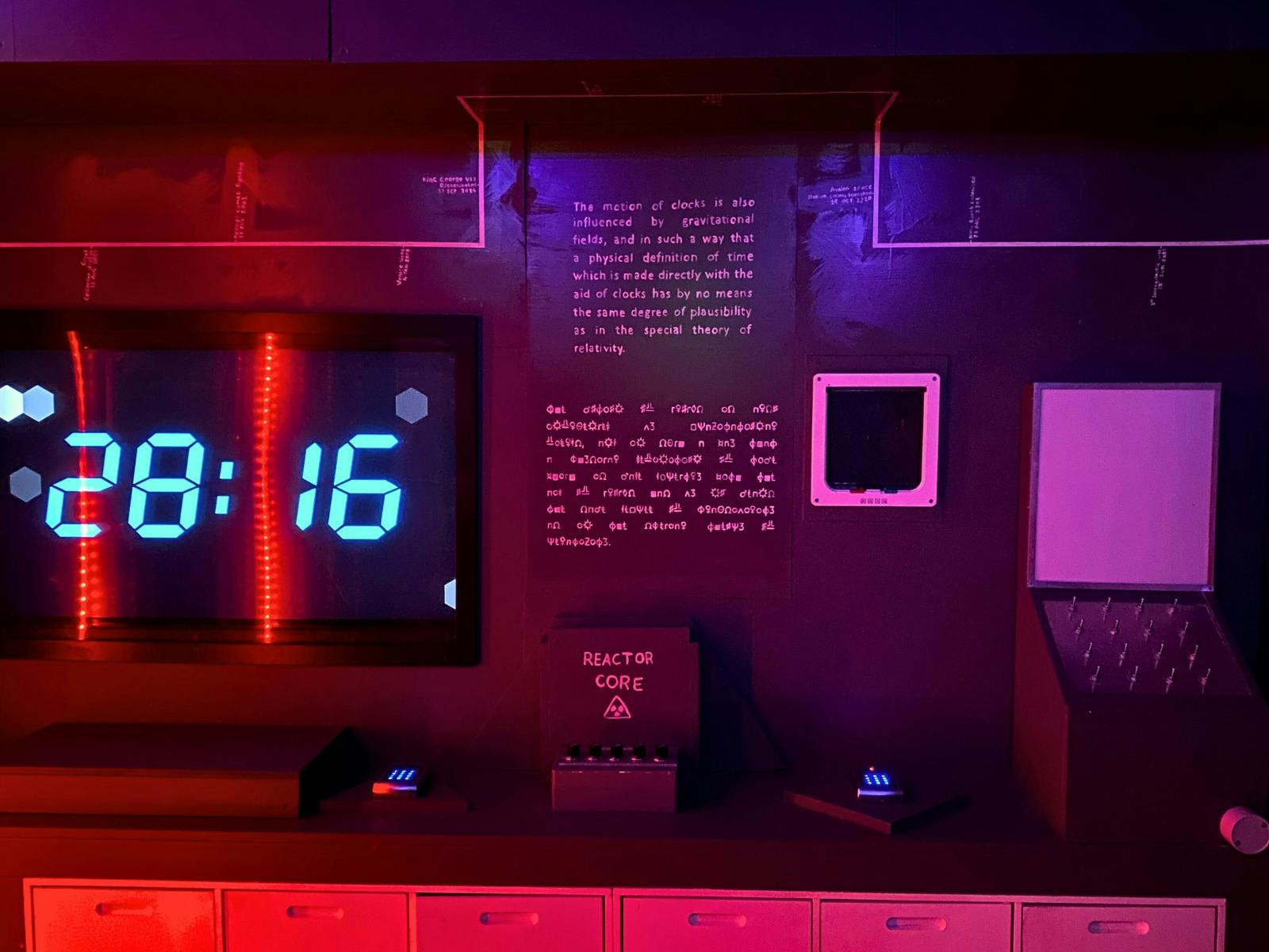 moody red and blue lighting in a room with text on the walls and a digital countdown
