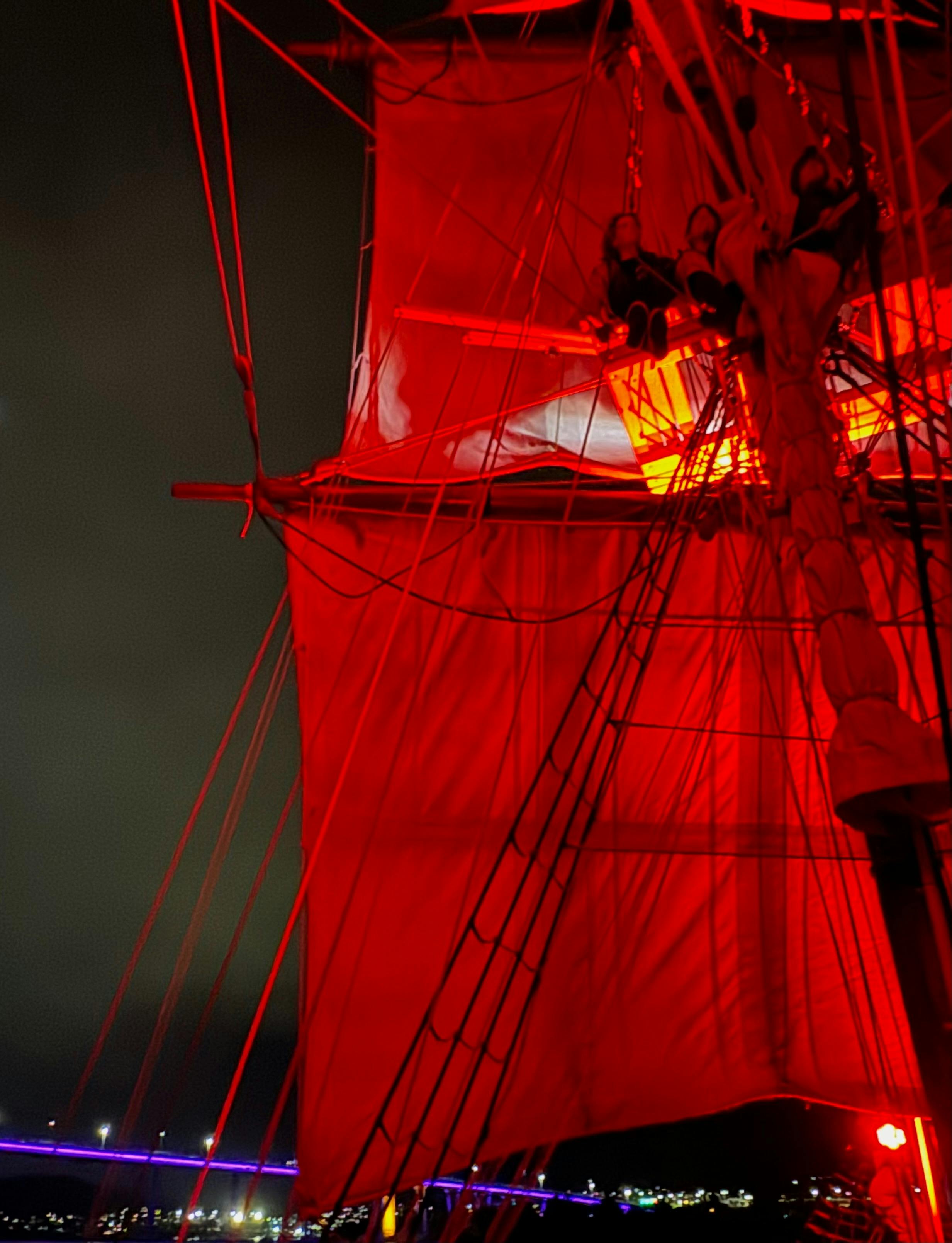 Crew members sitting aloft enjoying the event