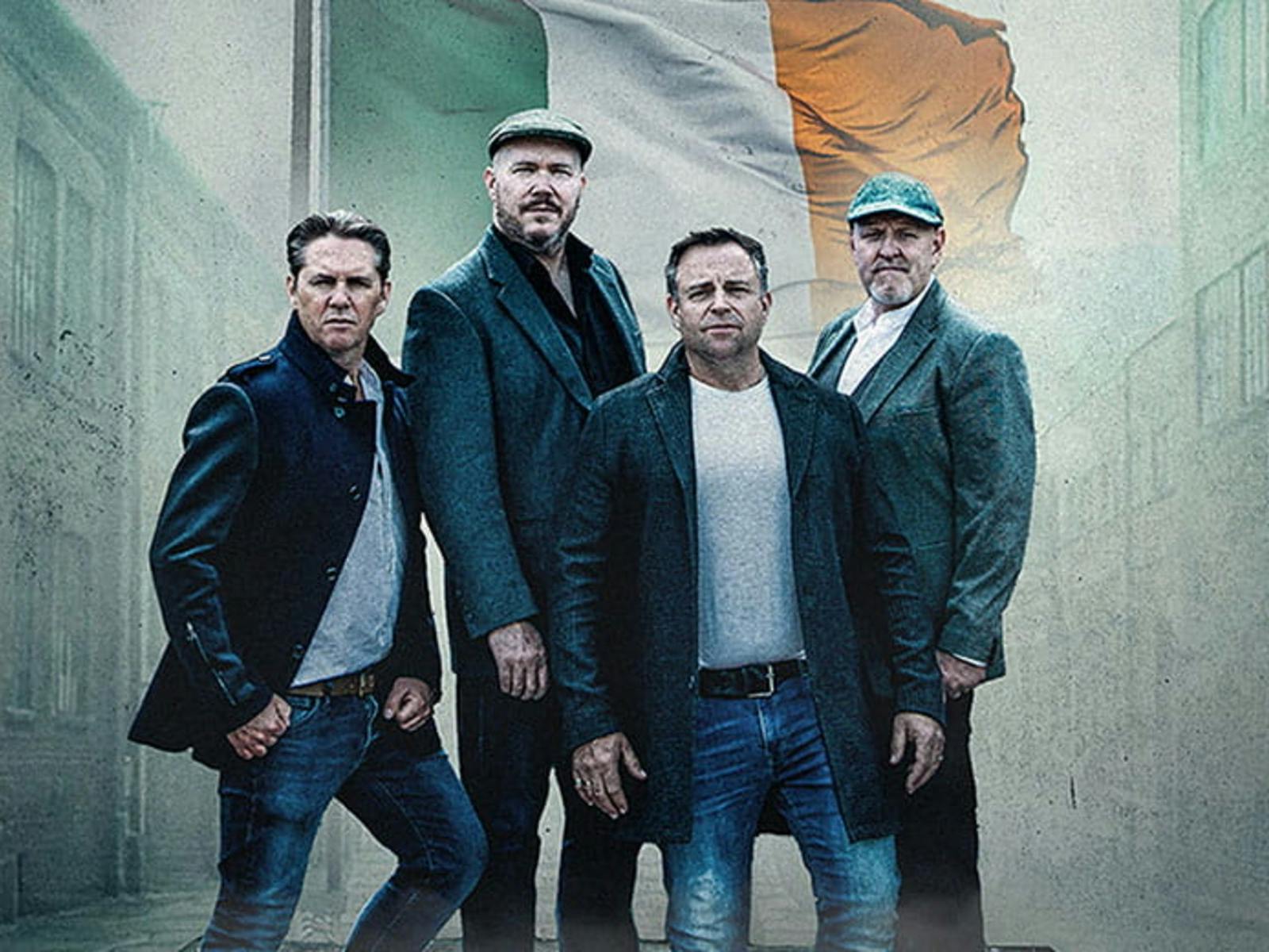 High kings standing in front of irish flag High kings standing in front of irish flag