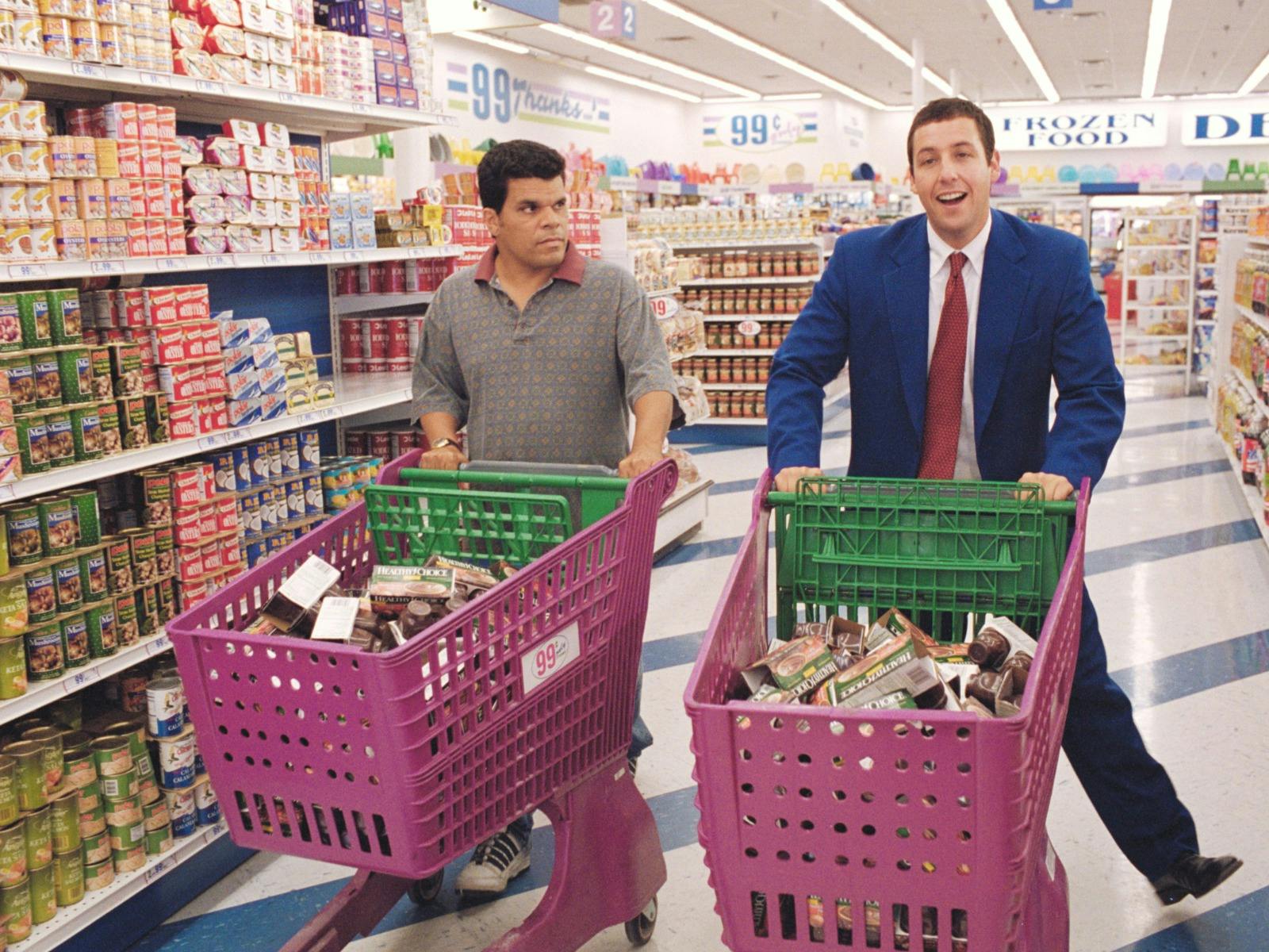 Two men in shopping centre with pink shopping trolleyrs