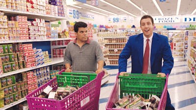 Two men in shopping centre with pink shopping trolleyrs