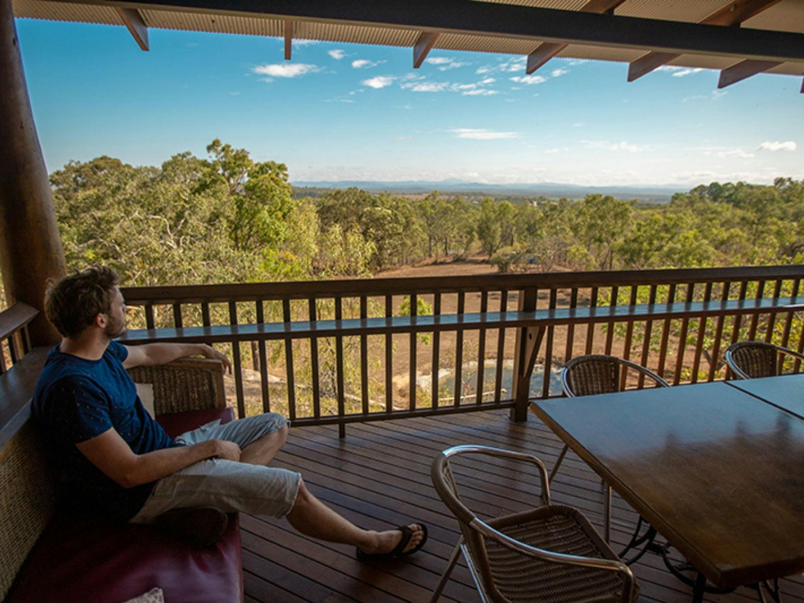 Man sitting and looking at a view of the Outback at Skybury Coffee Plantation and Cafe