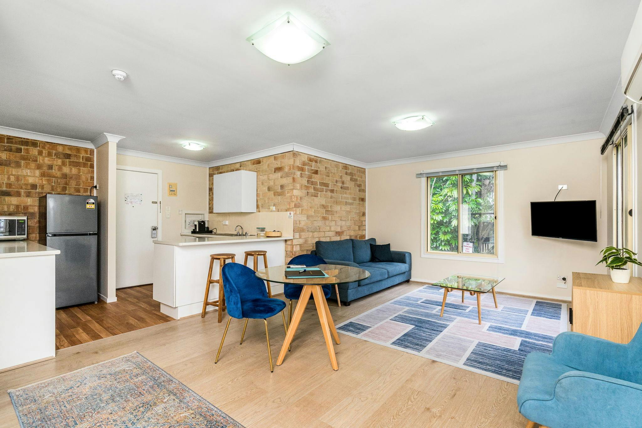 Spacious lounge and kitchen area in motel room