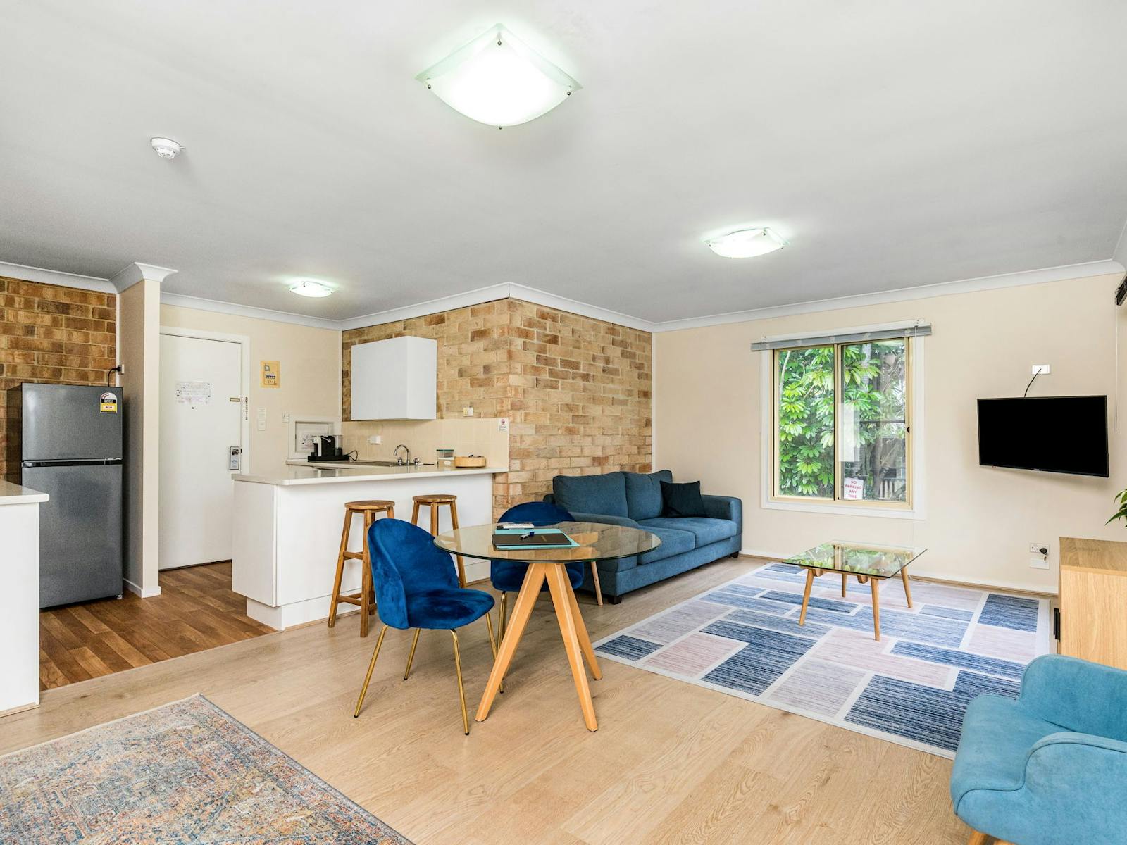 Spacious lounge and kitchen area in motel room