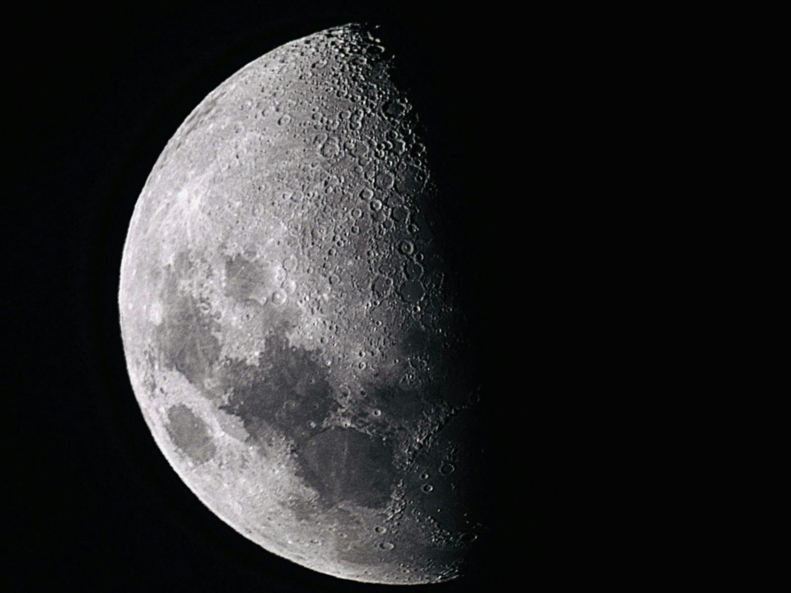 Close-up telescope image of the Crescent Moon against a dark sky.