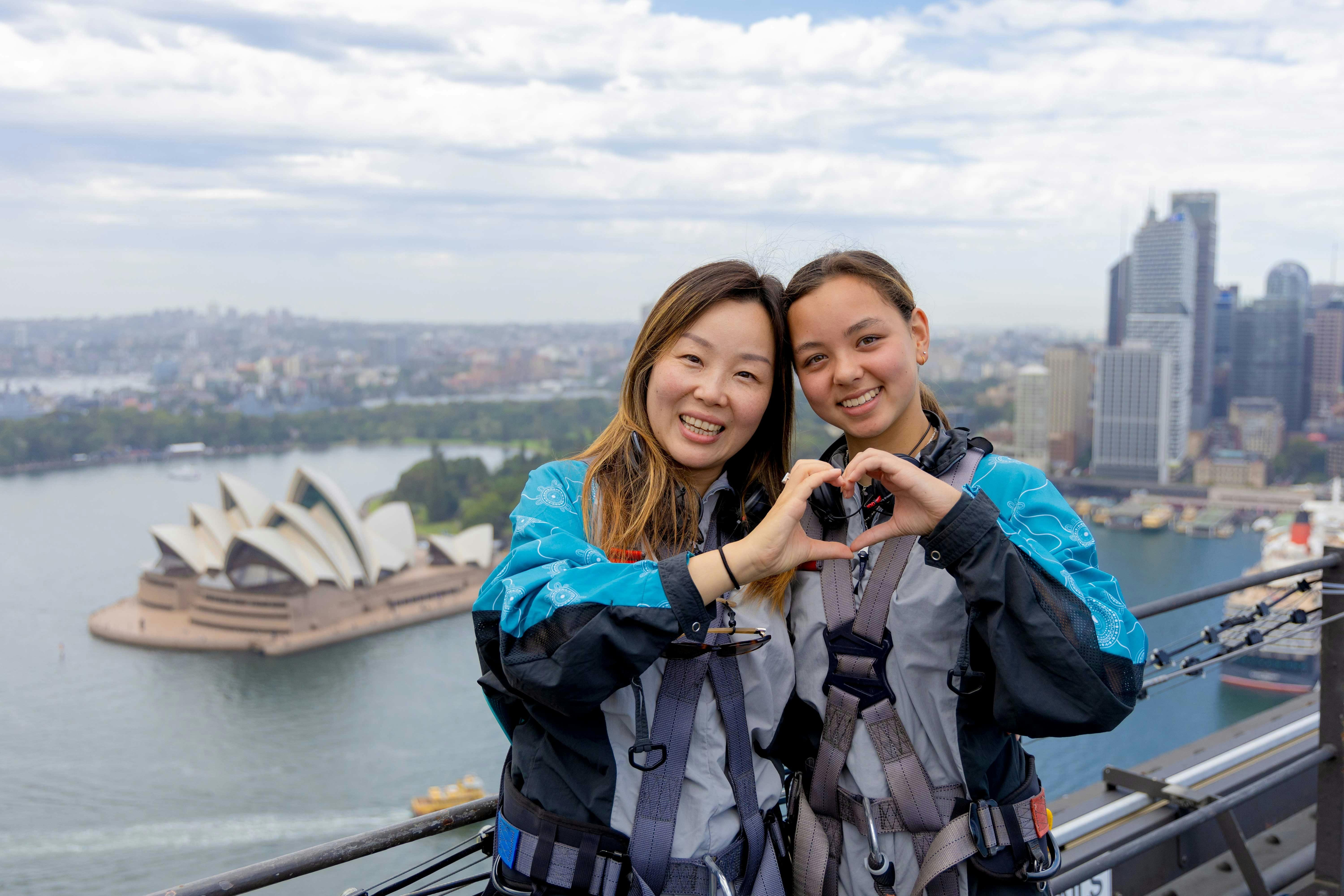Climbers on the upper arch of the Sydney Harbour Bridge with the Harbour behind
