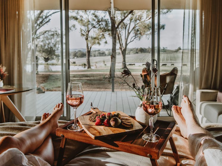 Wine and platter on bed