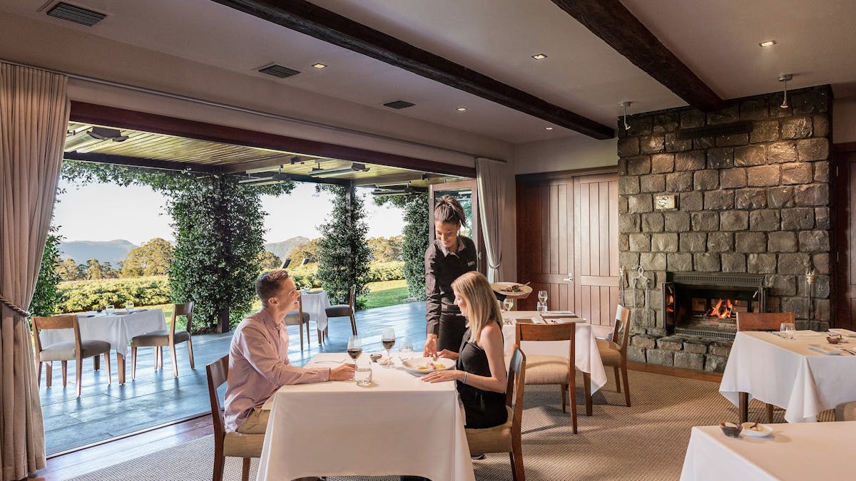 A couple dining at The Peak as a waittress serves them