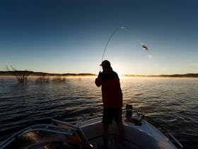 Fishing from a boat on Copeton Dam at Reflections Holiday Parks.