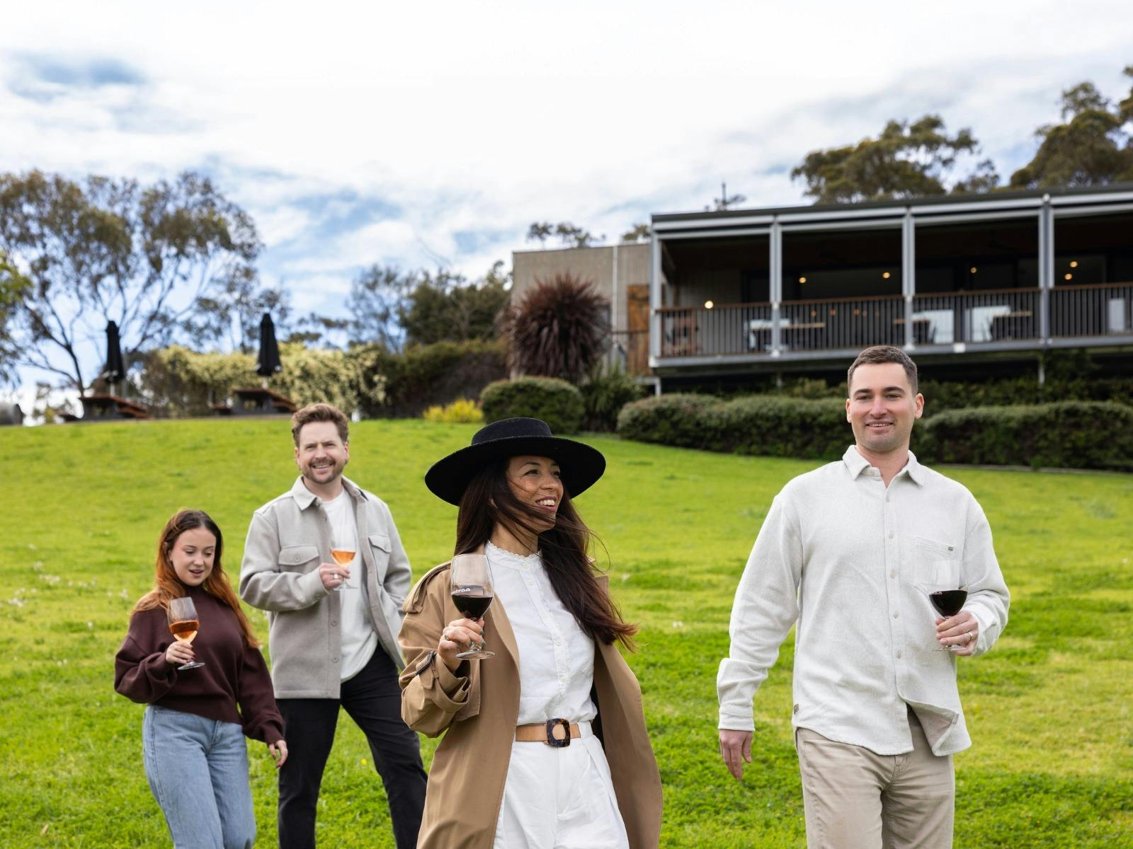 Four cusmoers walking on the grass in front of the Gemtree Tasting Room