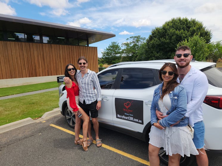 Photo of a Canberra winery tour EV parked with 2 couples posing