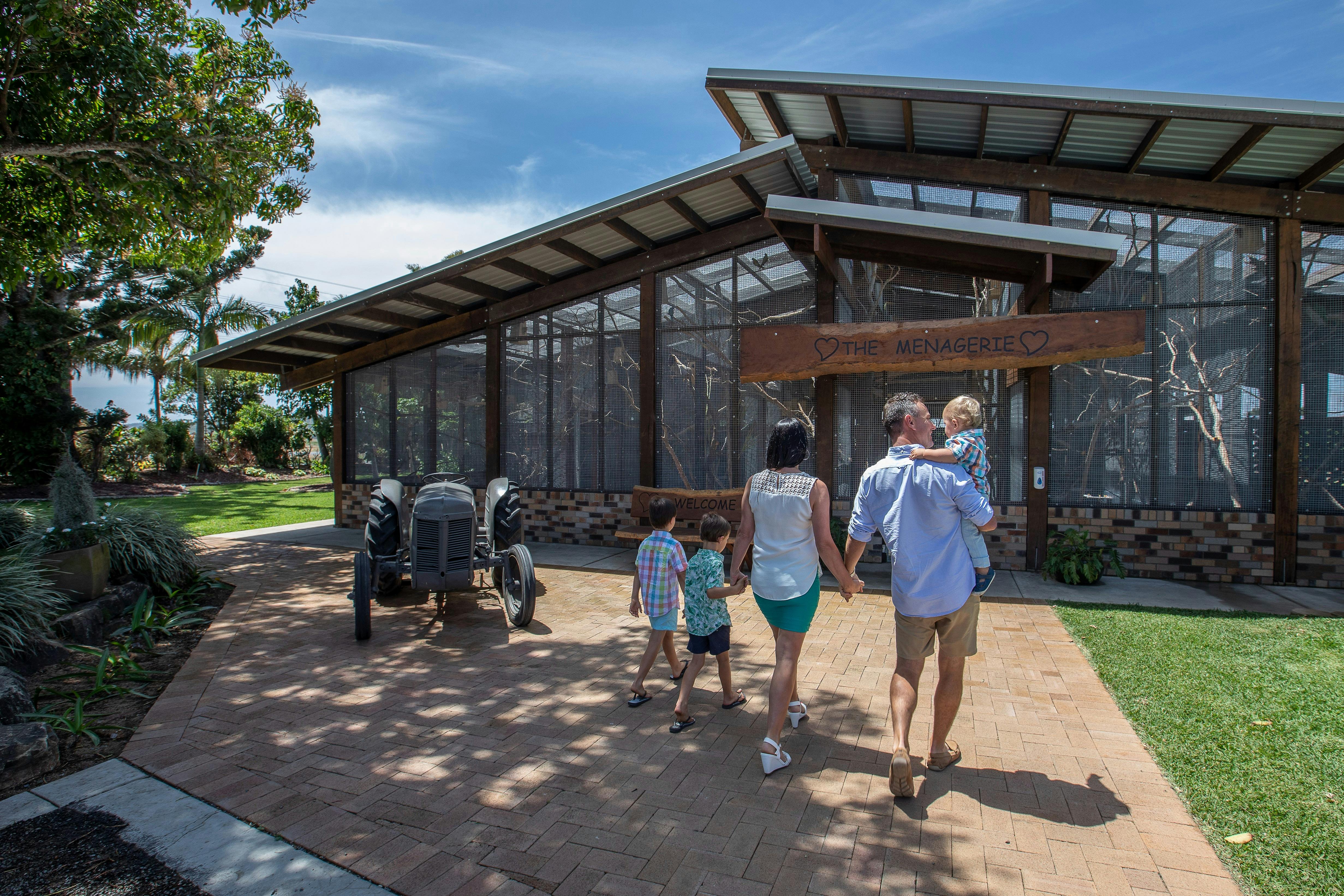 Family walking towards a large bird aviary