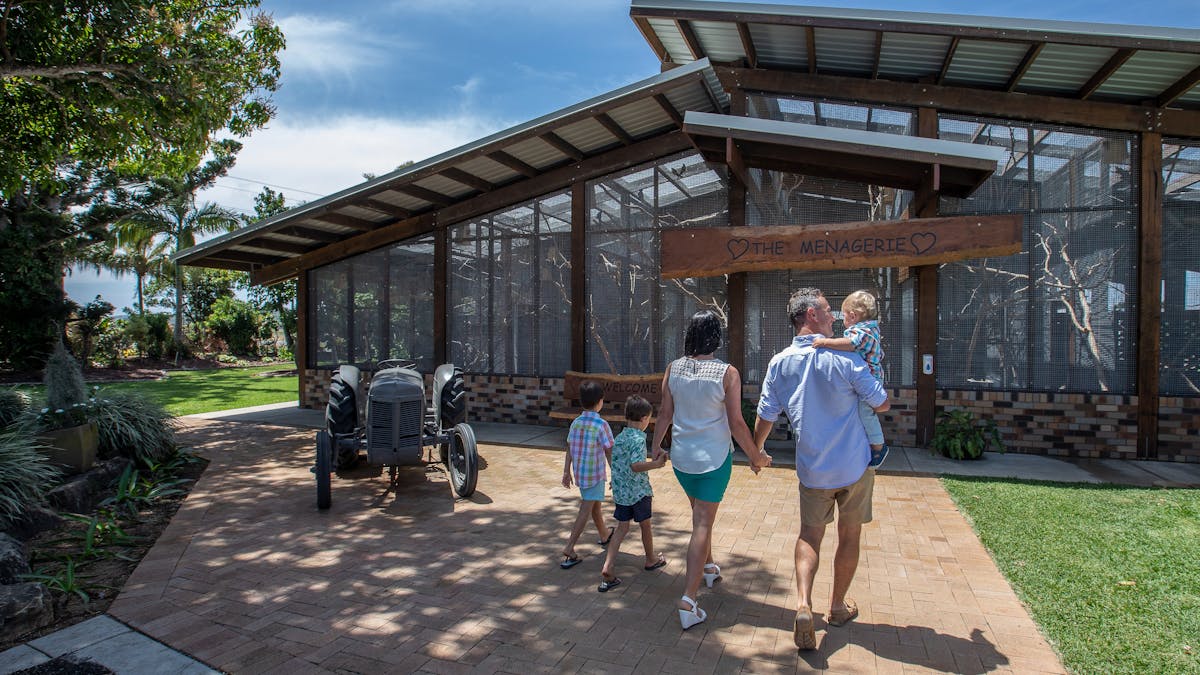 Family walking towards a large bird aviary