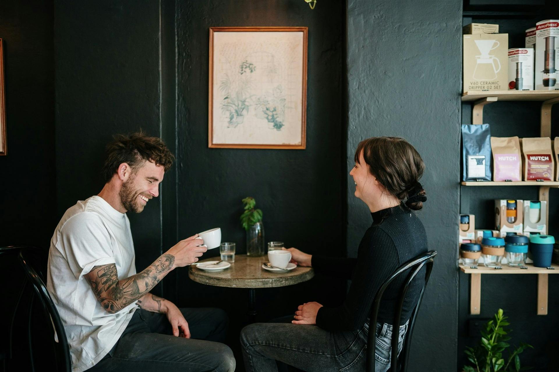 Two people drinking coffee in a cafe