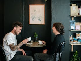 Two people drinking coffee in a cafe