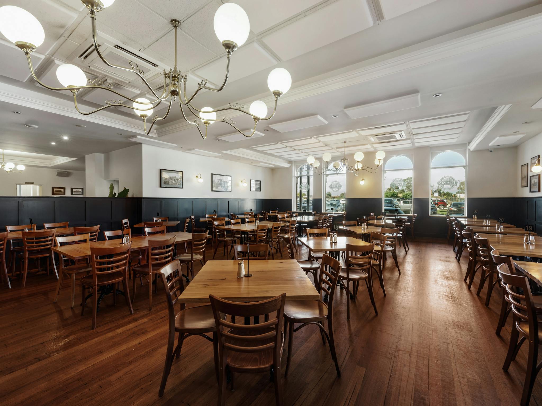 many dining tables and chairs set up inside the Bistro