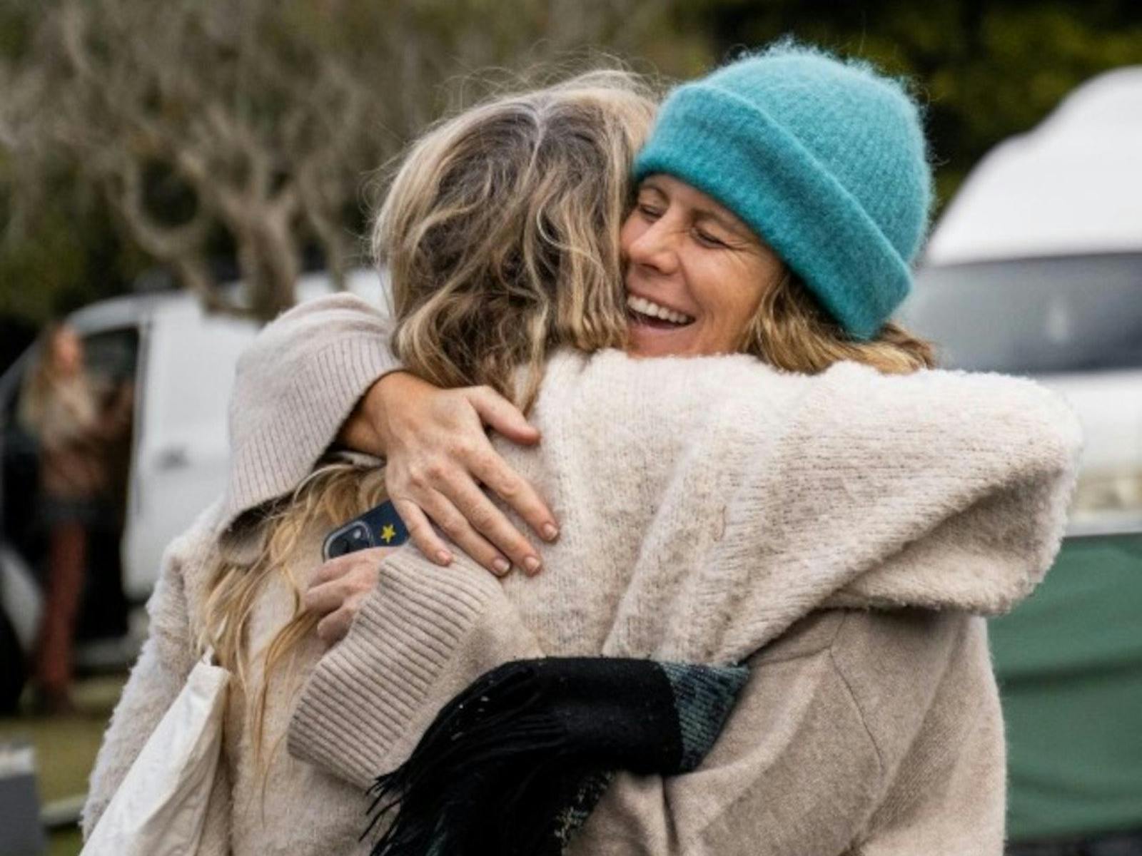 two women hugging and smiling