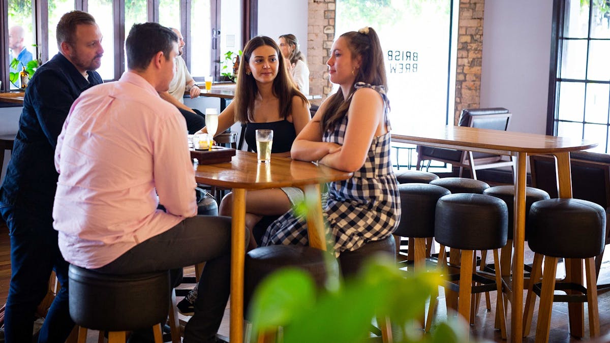 Four guests enjoying a beer and a chat
