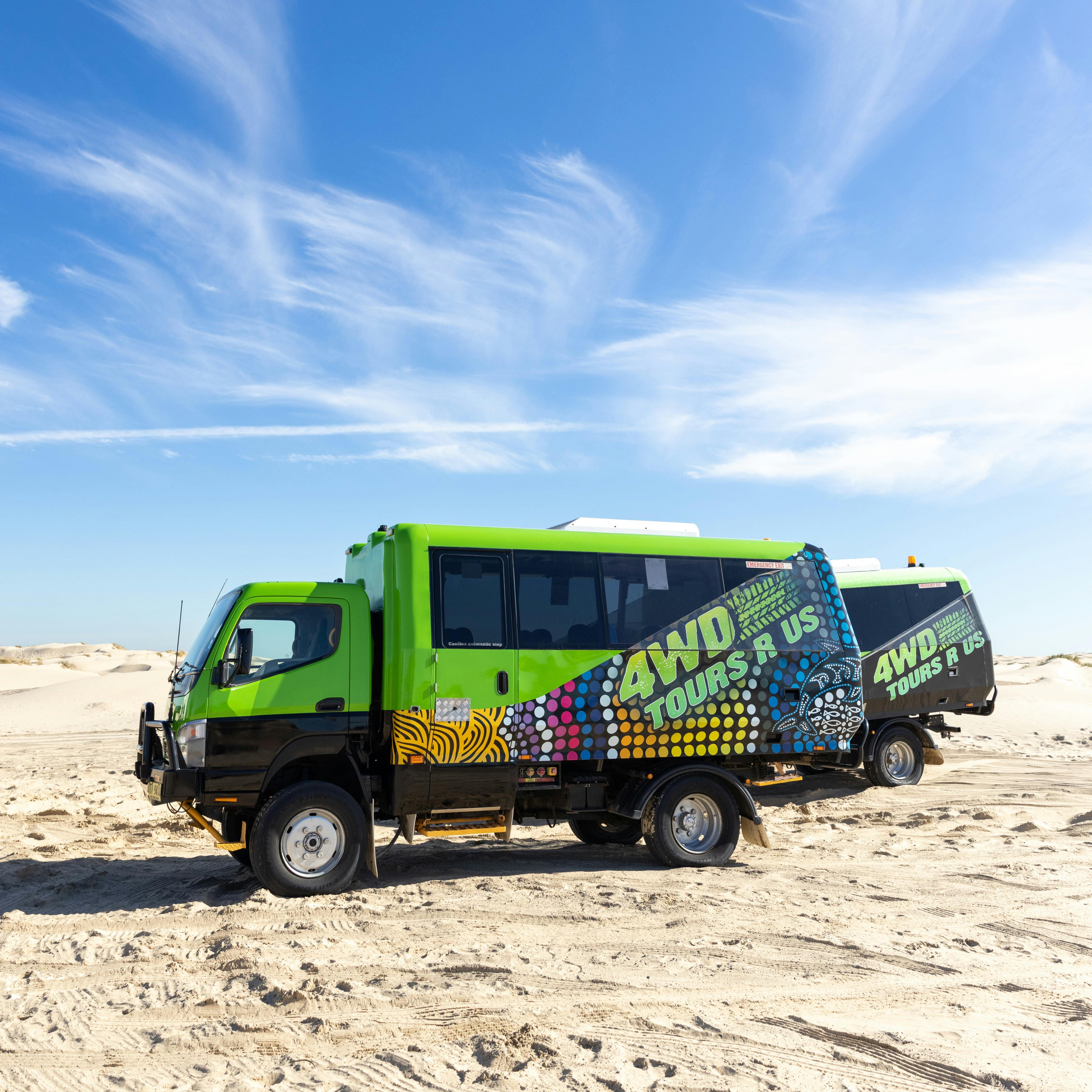 4WD Tours R Us green busses parked on sand dunes