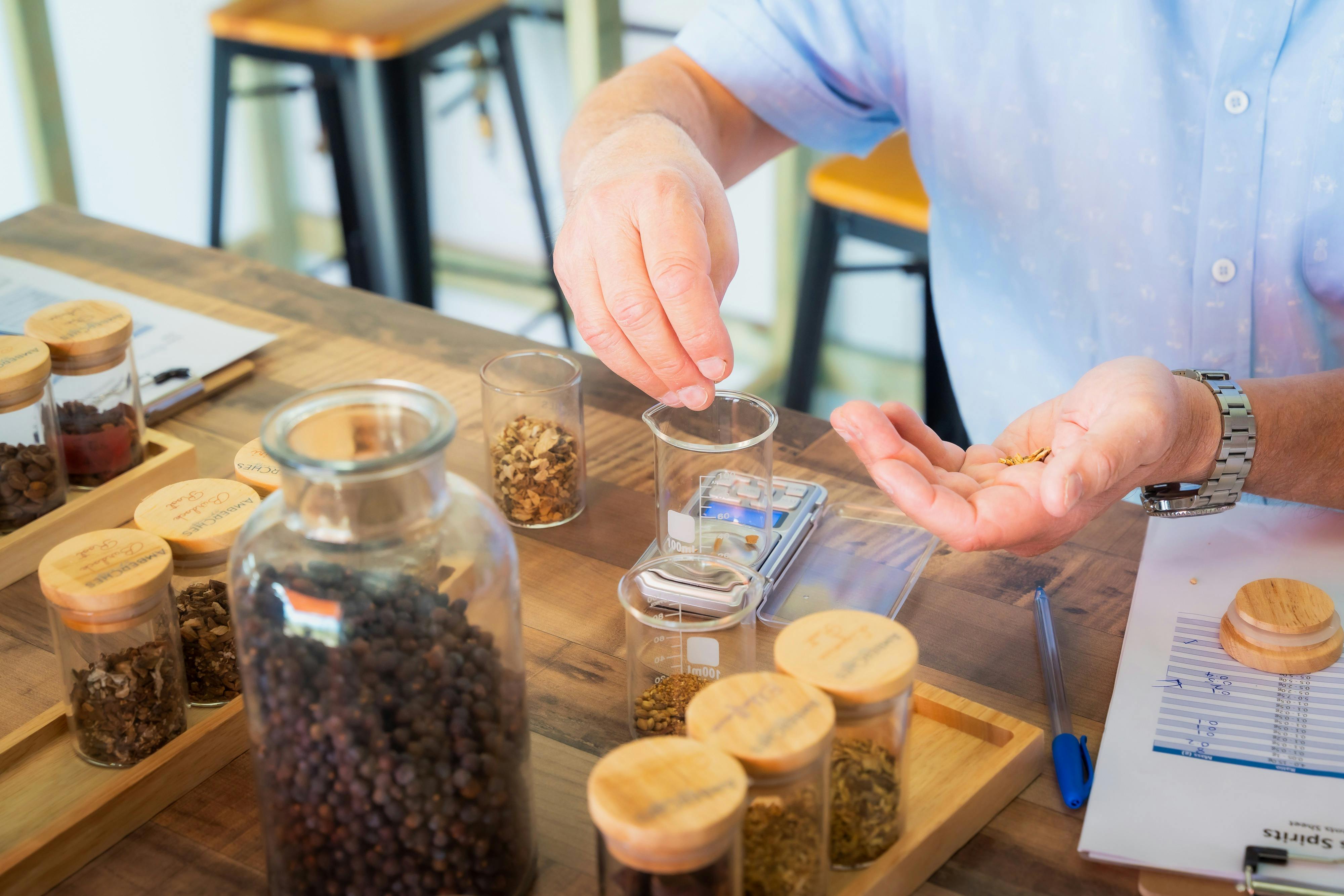 Measuring botanicals during a gin distilling class at AmberChes Spirits Distillery