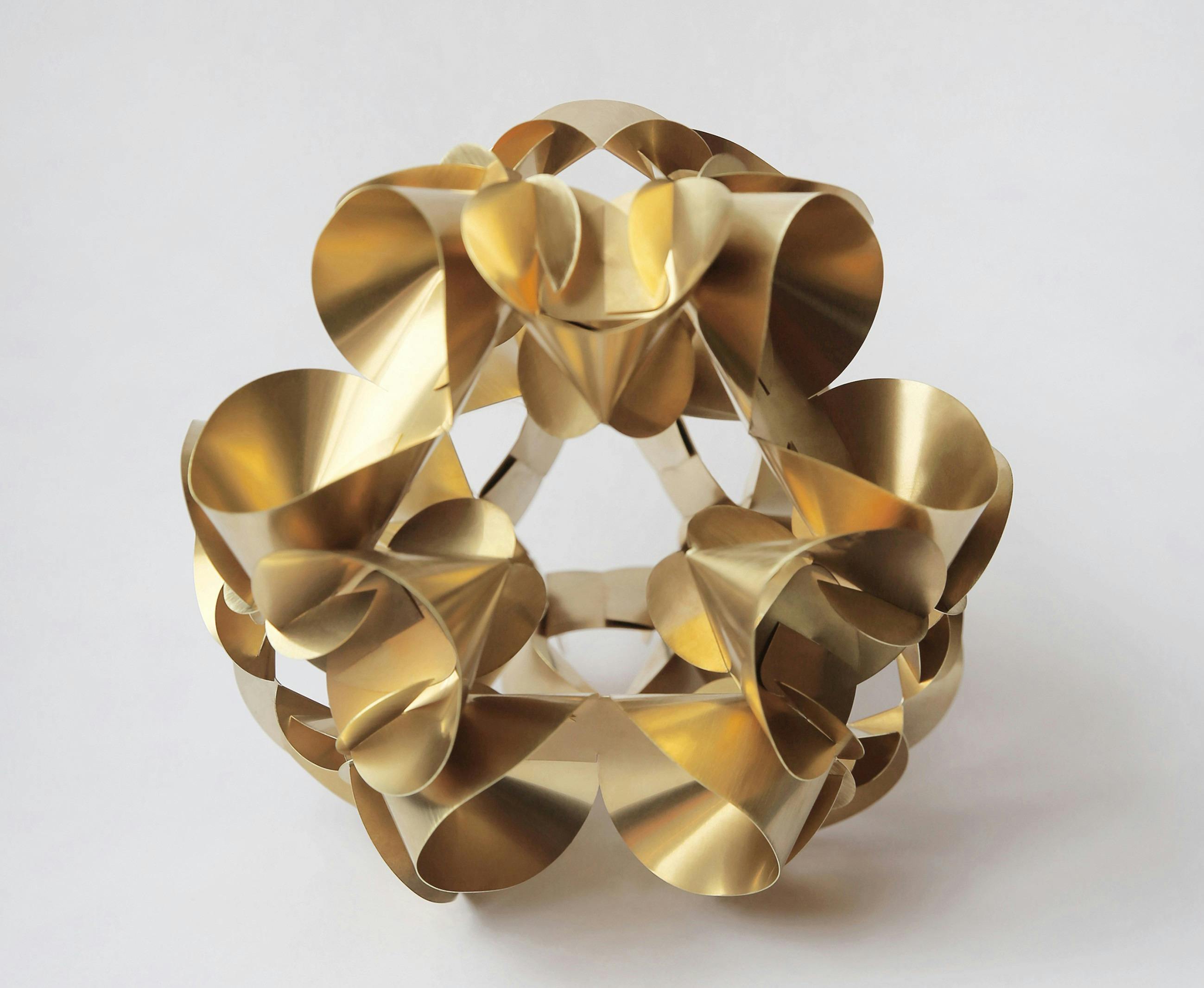 a copper sculpture resembling a stylised flower