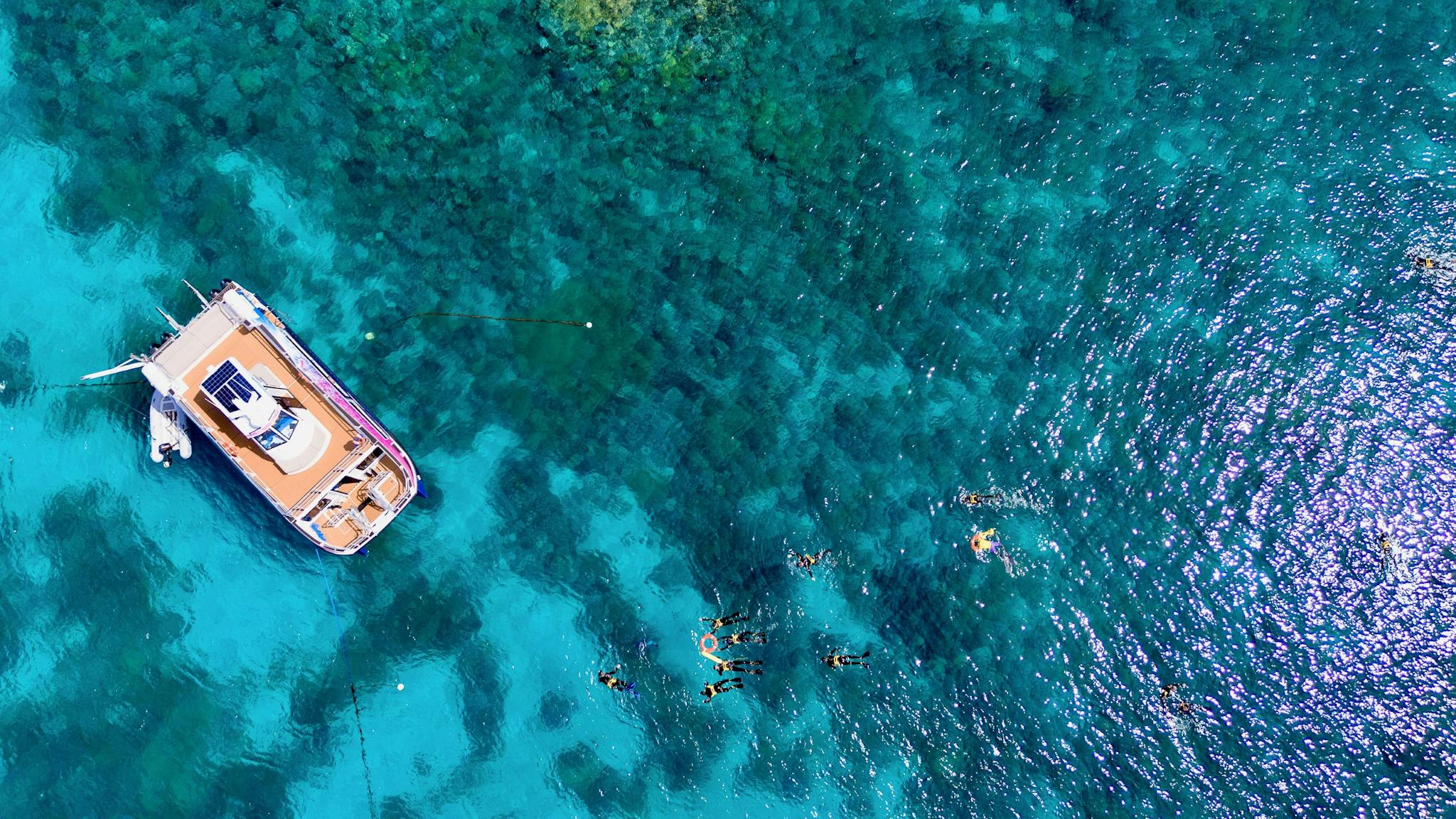 An ariel shot of Pure Snorkelling vessel with crystal clear waters on the Great Barrier Reef. An ariel shot of Pure Snorkelling vessel with crystal clear waters on the Great Barrier Reef.