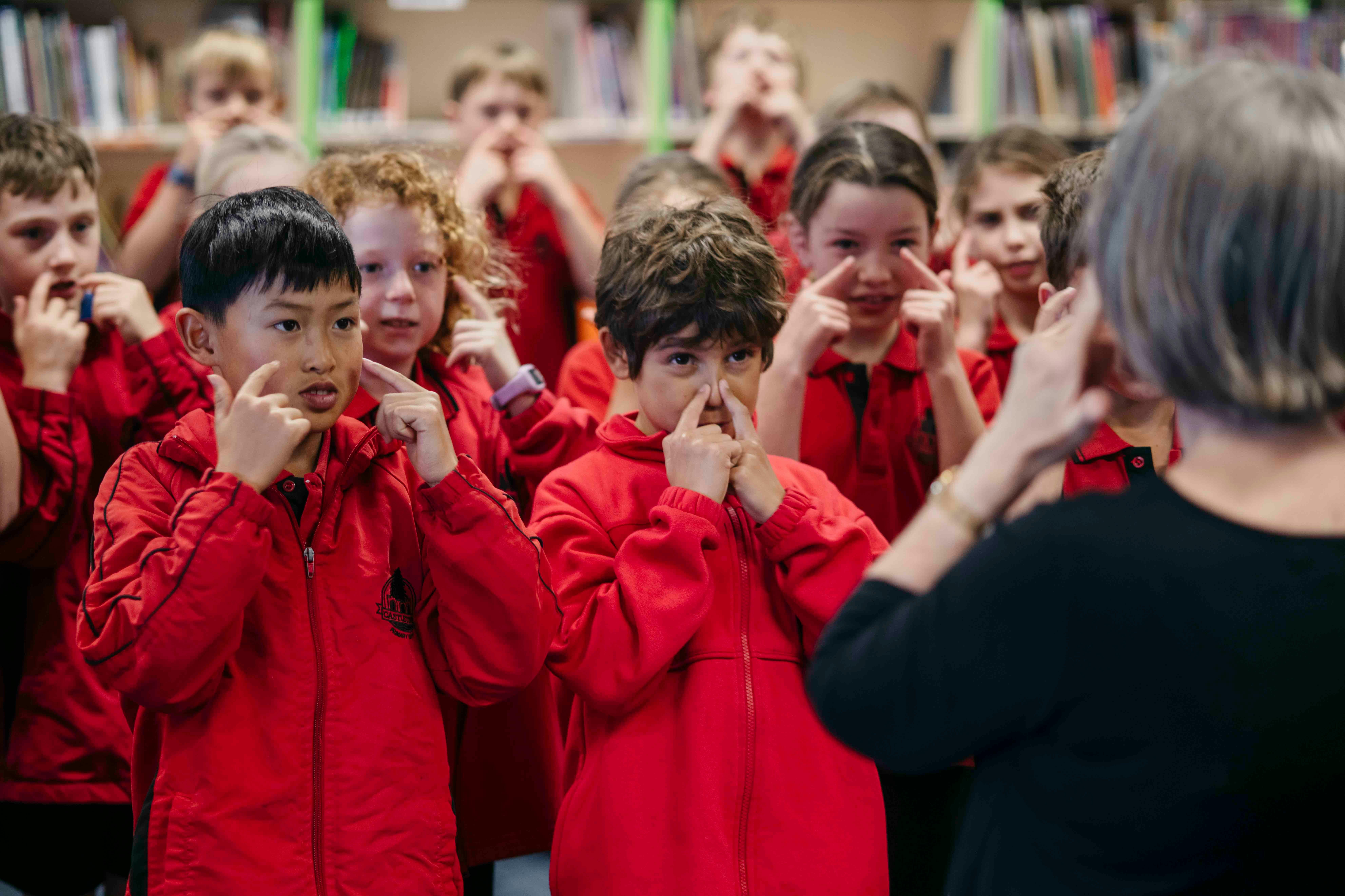 Children performing actions to music.