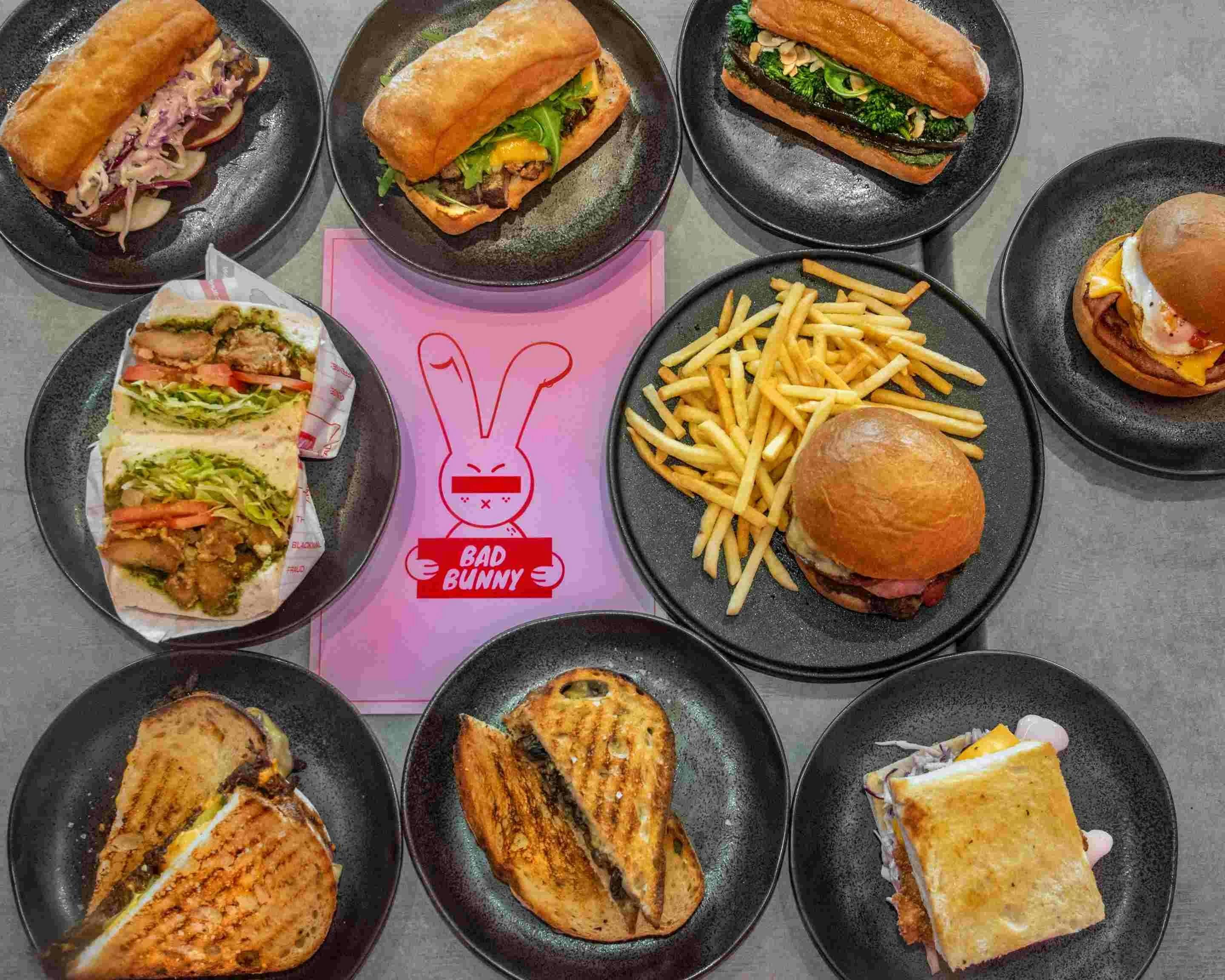 Image of various Bad Bunny food offerings: sandwiches, wraps, toasties and shoestring fries.