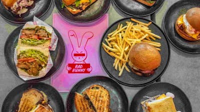 Image of various Bad Bunny food offerings: sandwiches, wraps, toasties and shoestring fries.