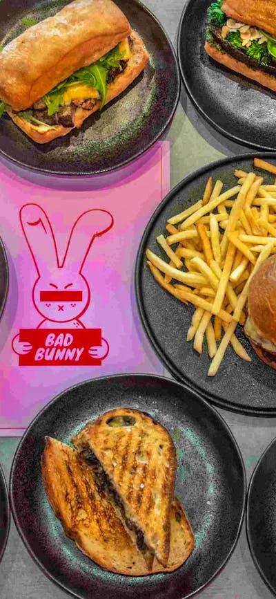 Image of various Bad Bunny food offerings: sandwiches, wraps, toasties and shoestring fries.