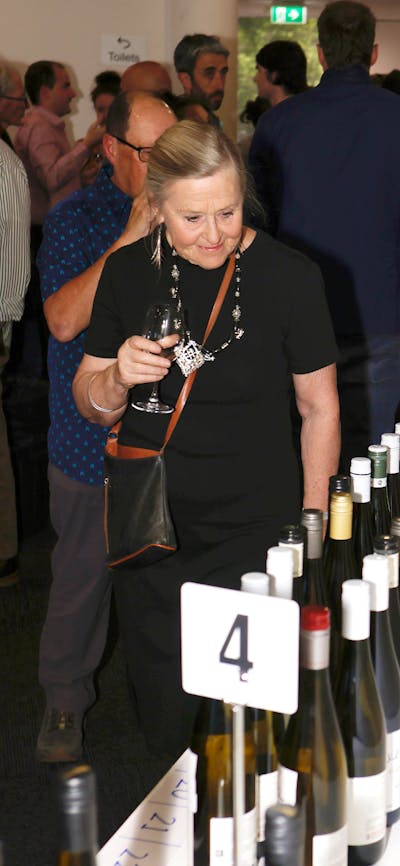 Lady looking at all the bottles of wine for tasting