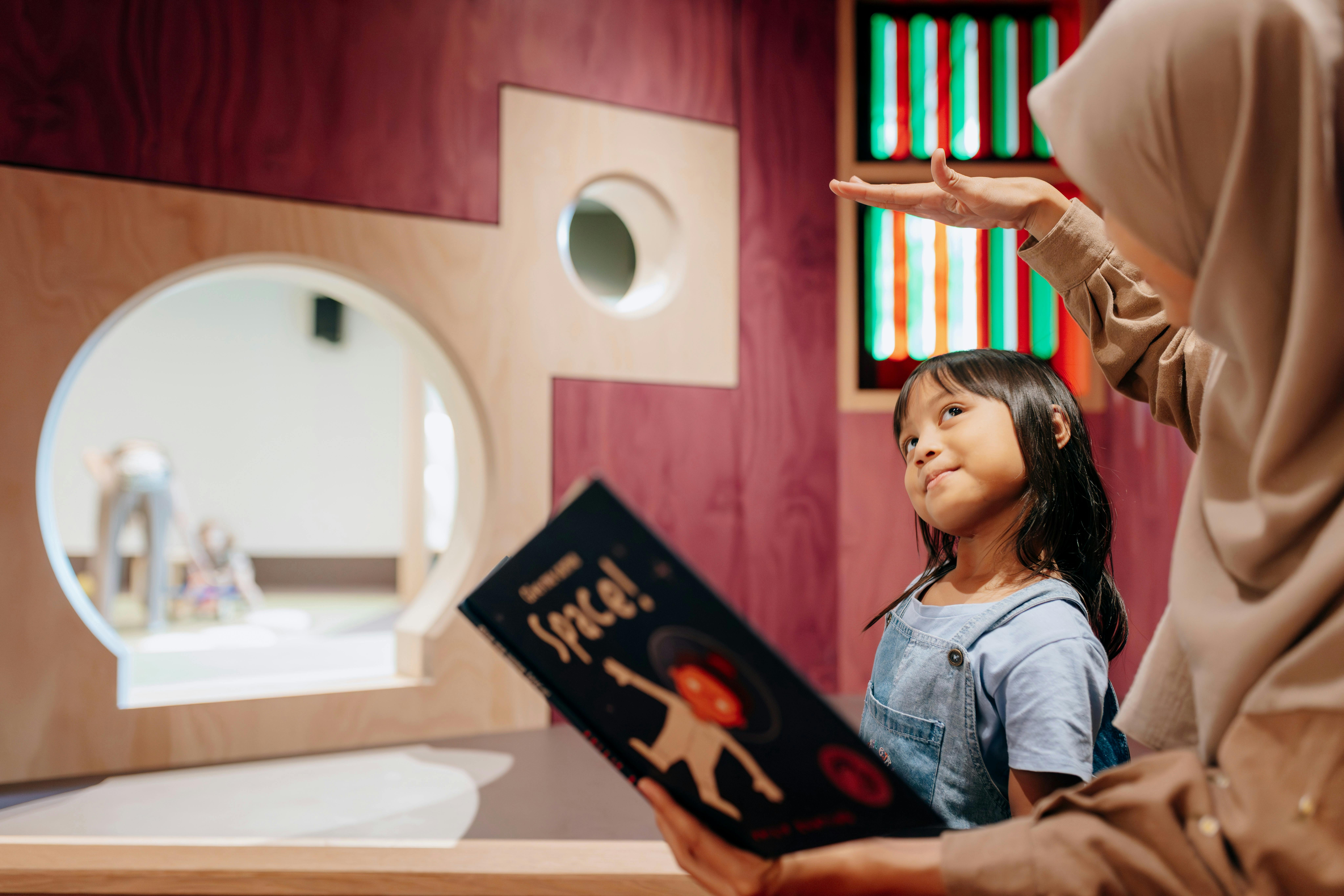 Children read books in nooks at The Corner