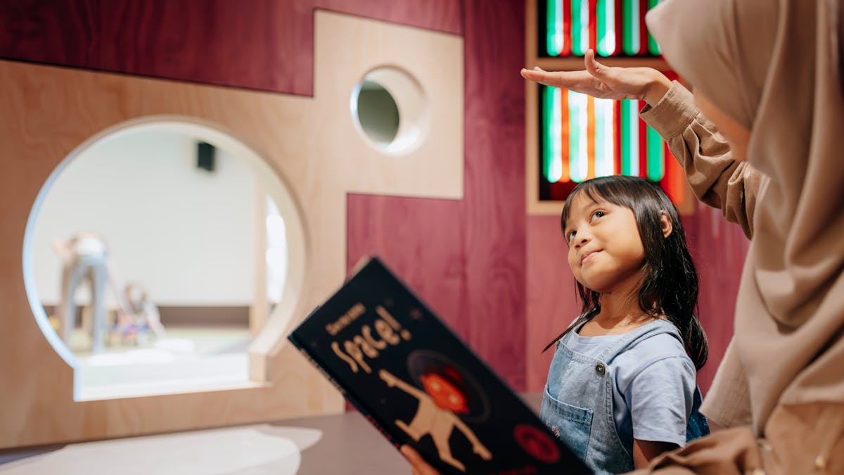 Children read books in nooks at The Corner